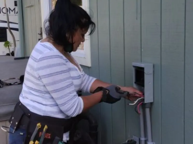 Licensed electrician wiring an exterior subpanel in Long Branch
