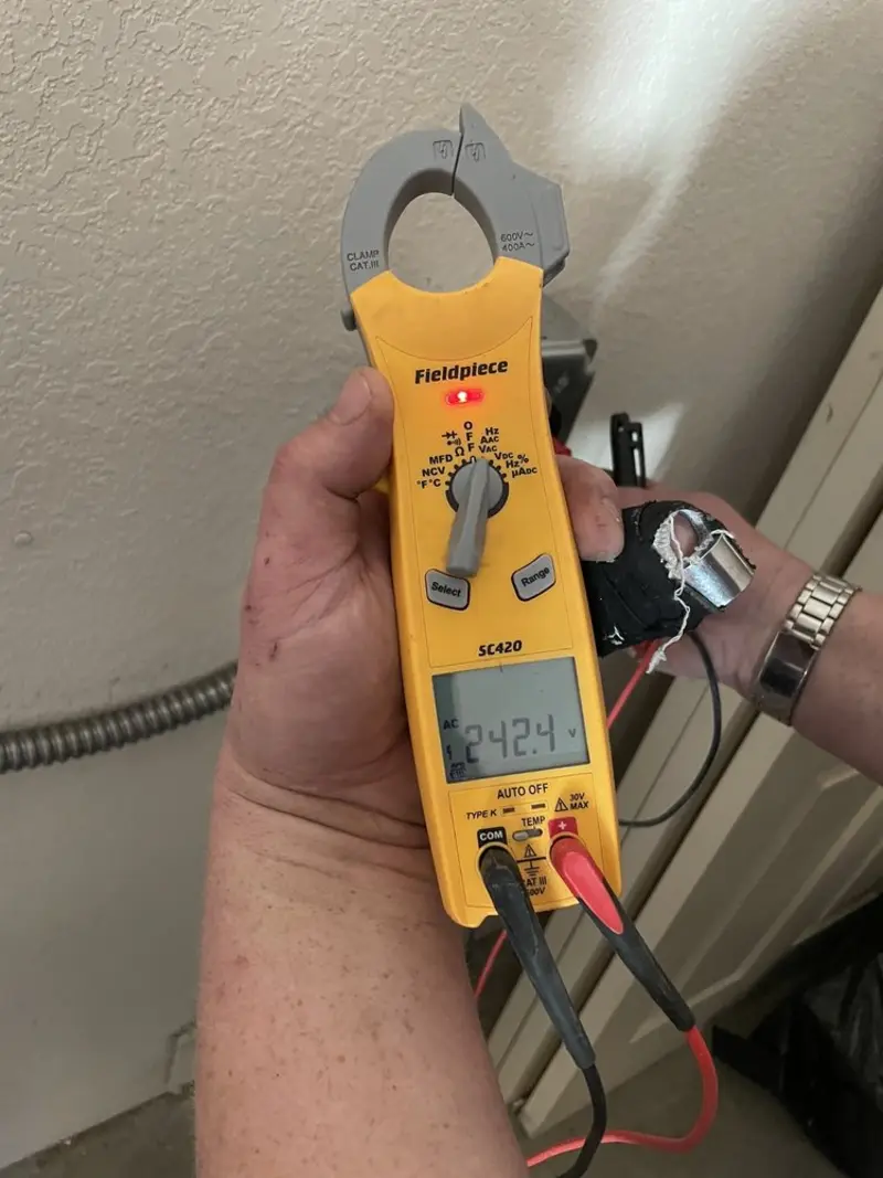 Voltage testing with clamp meter during Ceiling Fan Installation in Long Branch